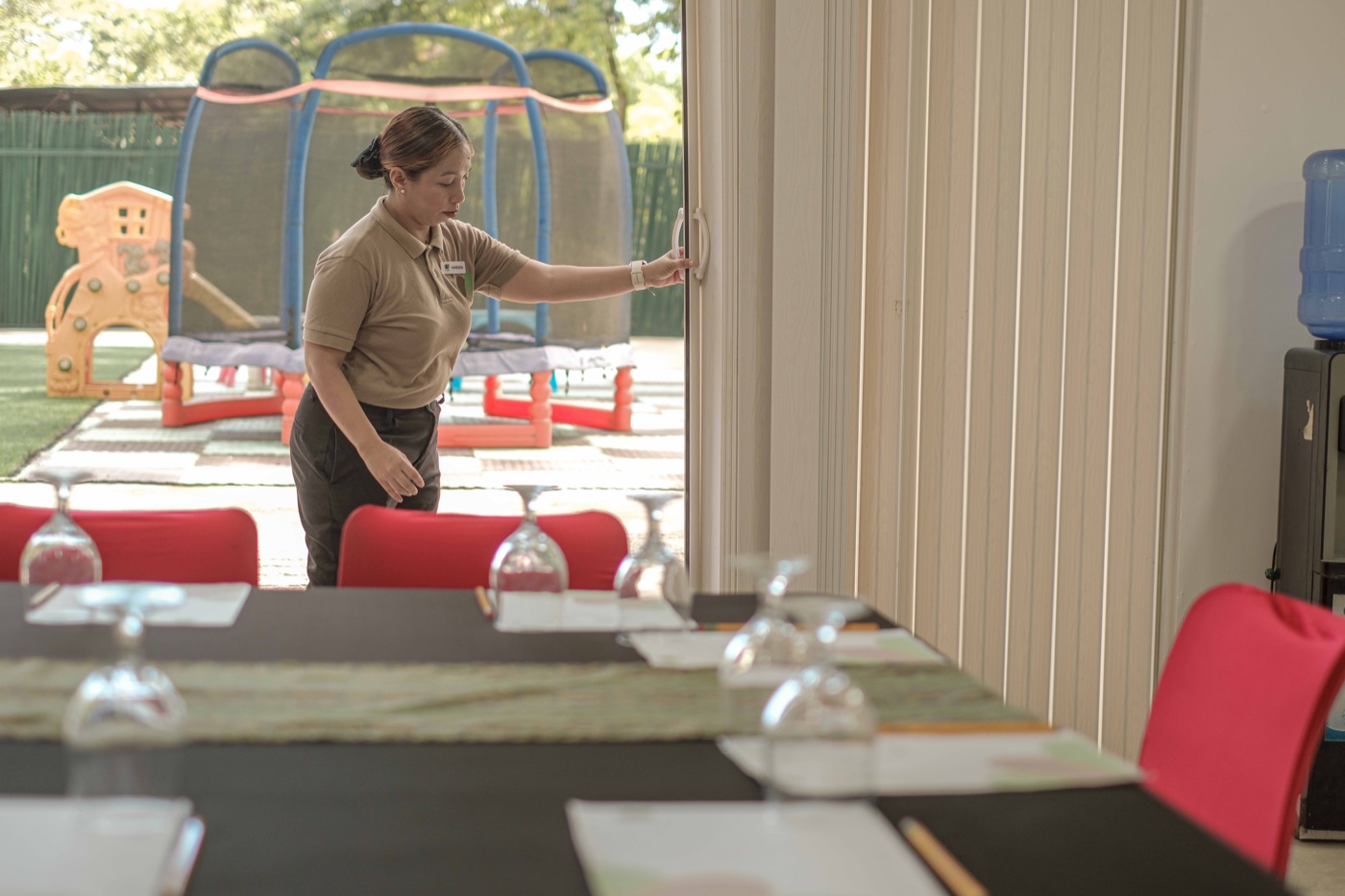 Staff opening the Pavilion's accordion doors onto the courtyard