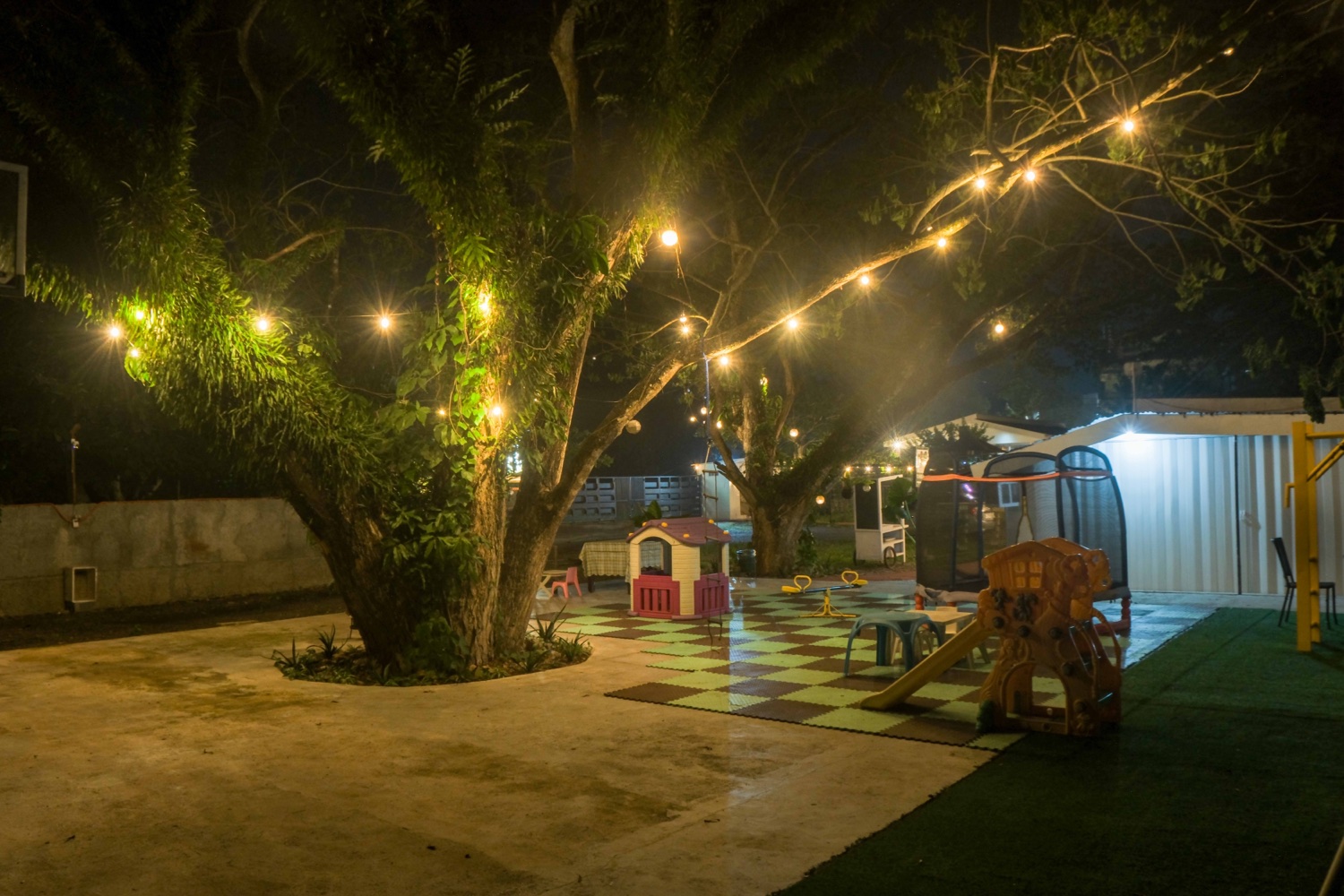 The garden courtyard under string lights