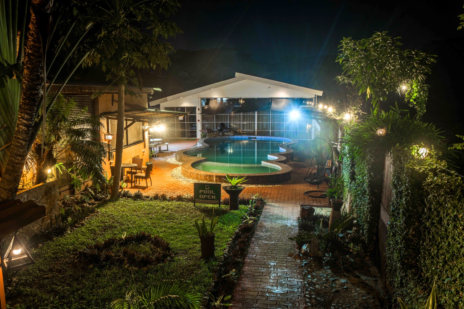 The pool and garden path at night